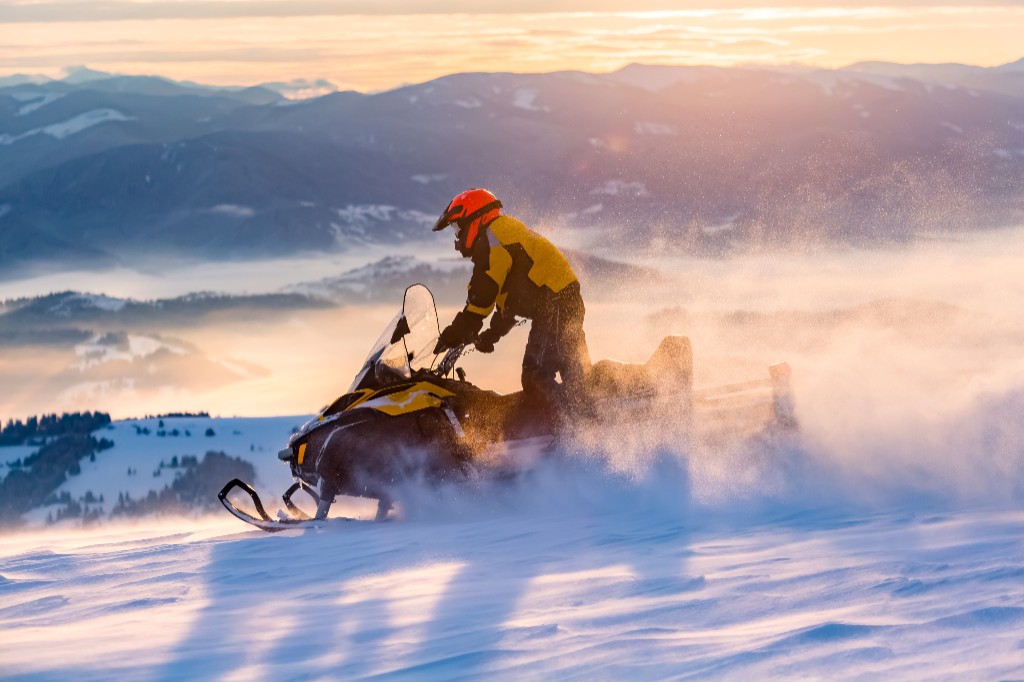 Snowmobile rider on a snowy ridge